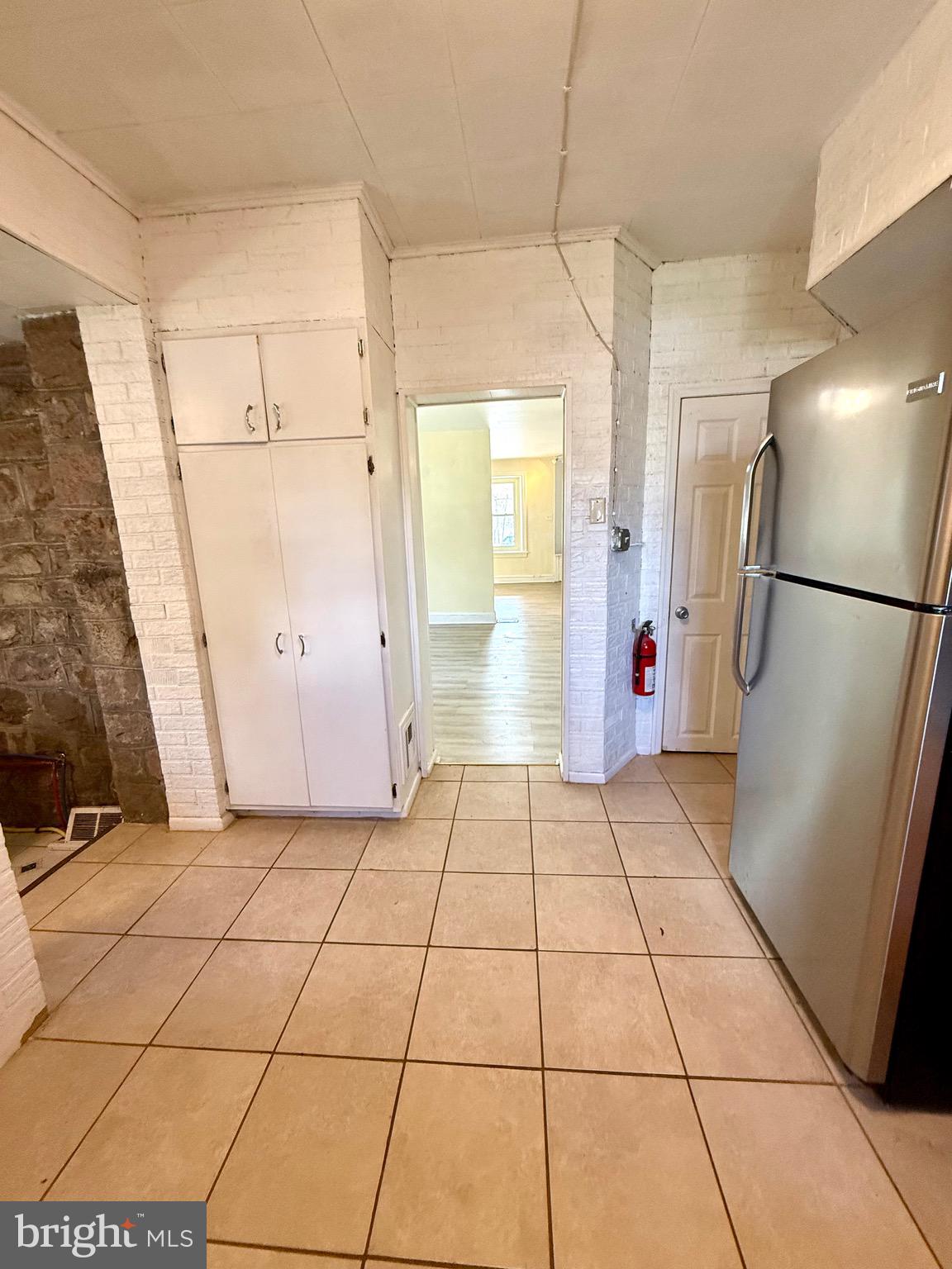 403 South Main Street Ambler, PA 19002 - Photo 12 of 37 a view of a refrigerator in kitchen and an empty room