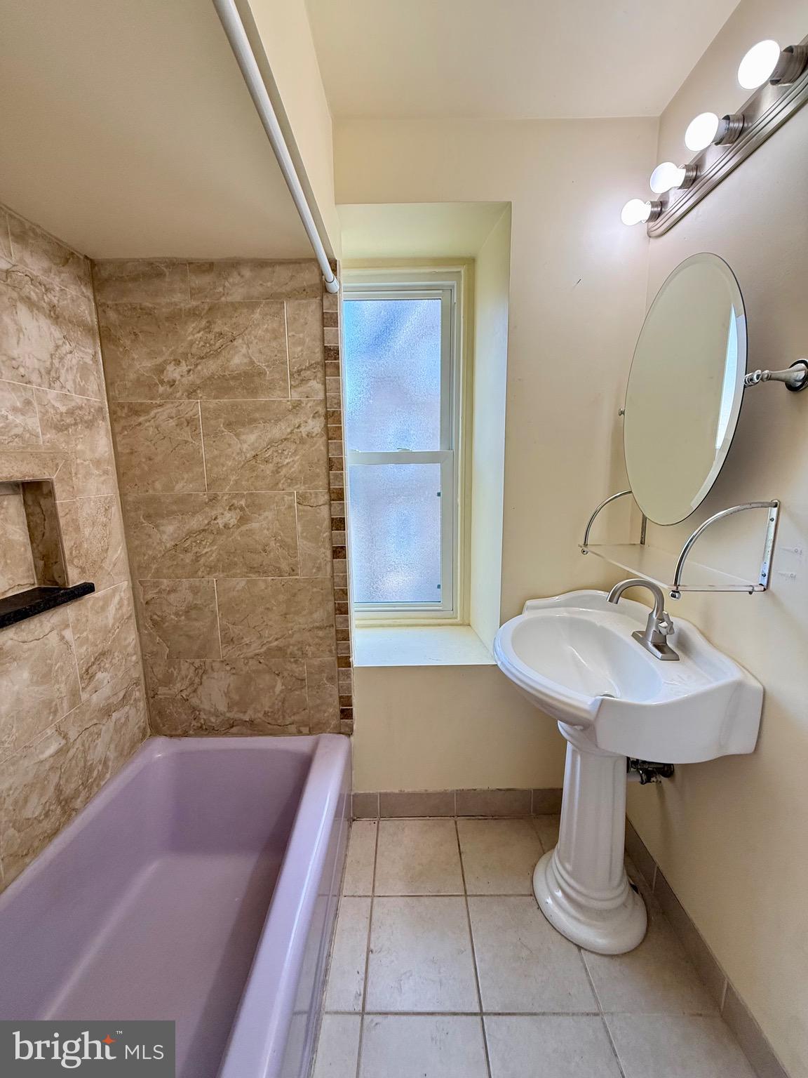 403 South Main Street Ambler, PA 19002 - Photo 24 of 37 a bathroom with a sink a bathtub and a mirror
