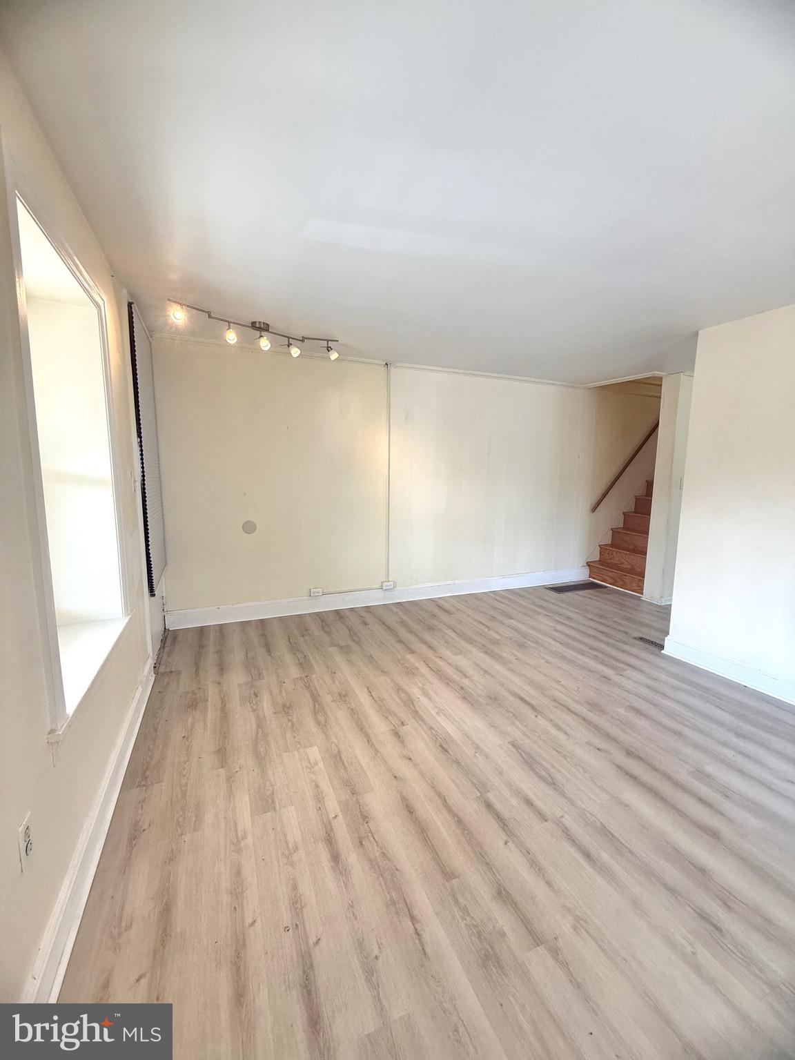 403 South Main Street Ambler, PA 19002 - Photo 5 of 37 an empty room with wooden floor and windows