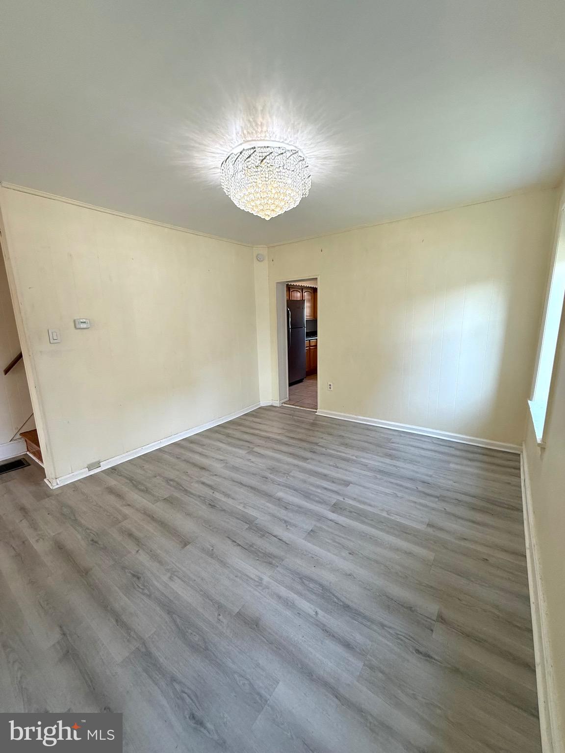 403 South Main Street Ambler, PA 19002 - Photo 9 of 37 an empty room with wooden floor chandelier and windows