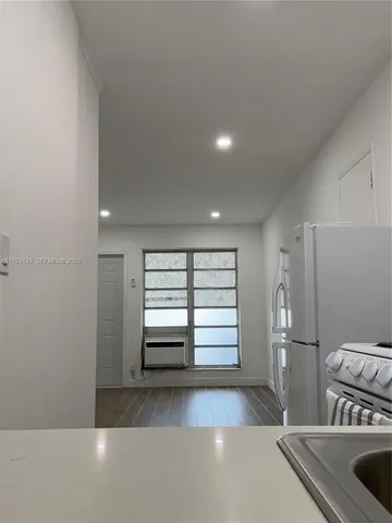 a view of a kitchen with a sink dishwasher and a refrigerator