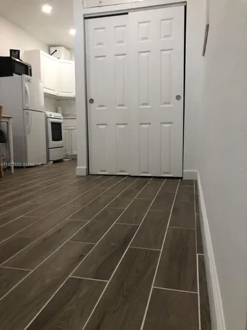 a view of a room with wooden floor and white doors