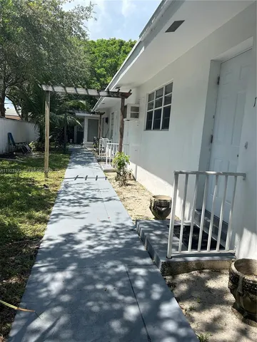 a view of a house with backyard porch and sitting area