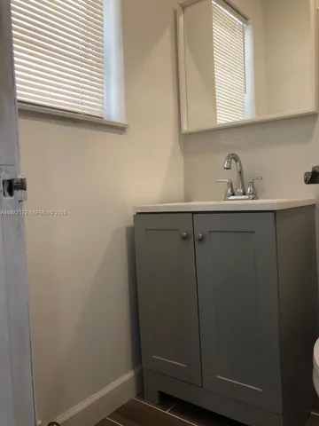 a bathroom with a sink and cabinets