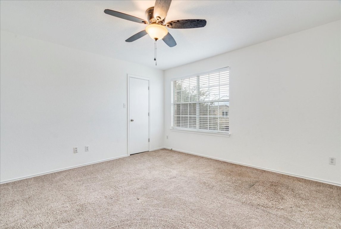 18436 Wind Tree Lane Elgin, TX 78621 - Photo 22 of 34 an empty room with a window and a fan