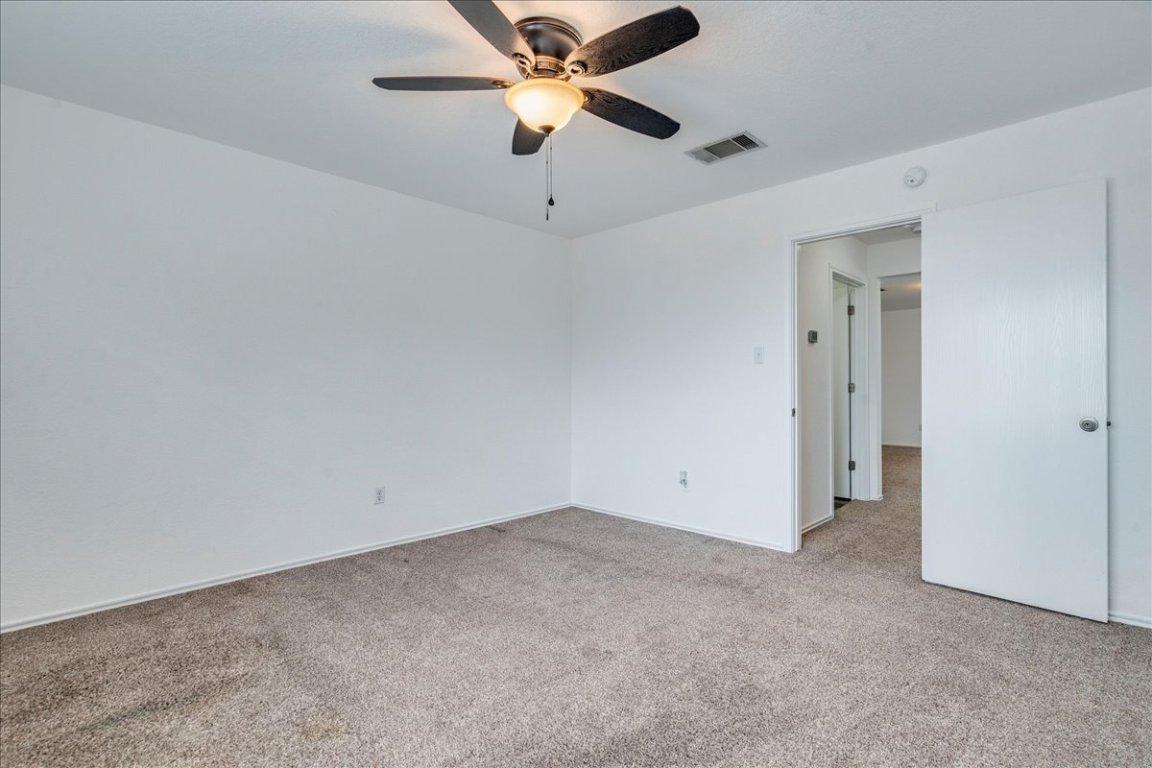 18436 Wind Tree Lane Elgin, TX 78621 - Photo 23 of 34 an empty room with chandelier fan