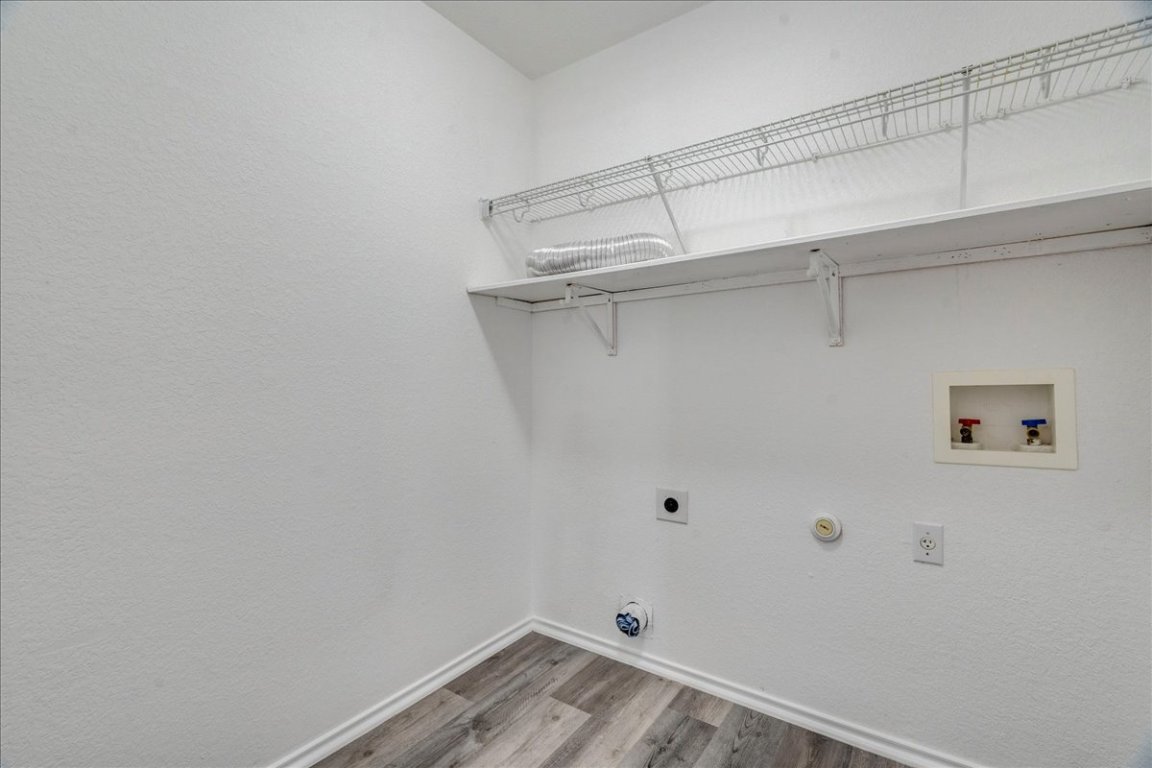 18436 Wind Tree Lane Elgin, TX 78621 - Photo 25 of 34 a view of a room with racks on the wall