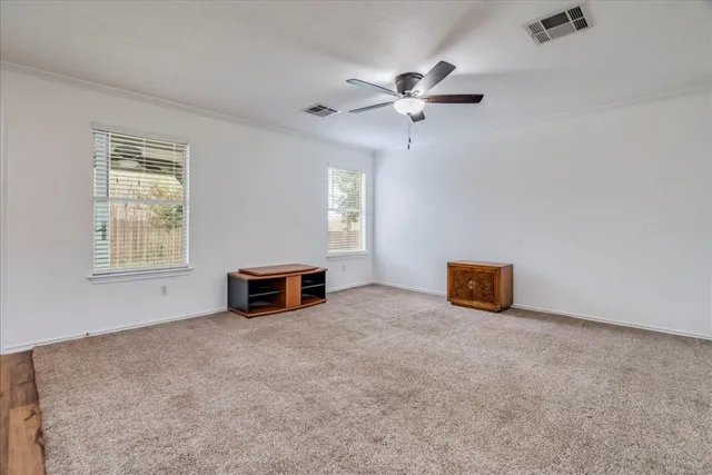 a view of a livingroom with furniture and a ceiling fan