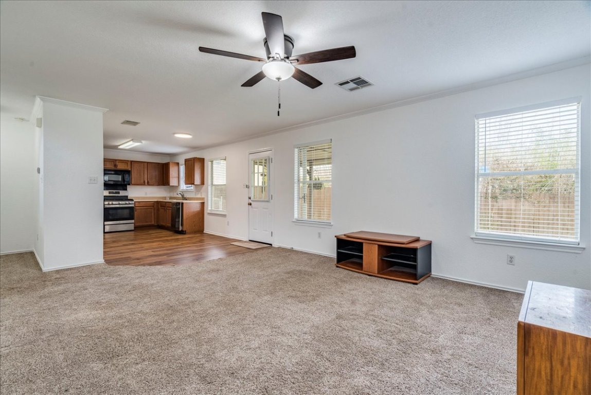 18436 Wind Tree Lane Elgin, TX 78621 - Photo 34 of 34 a view of a livingroom with furniture and a ceiling fan