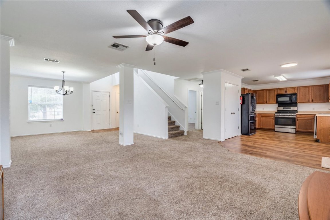 18436 Wind Tree Lane Elgin, TX 78621 - Photo 4 of 34 Additional view living area featuring view of kitchen, dining and stairway