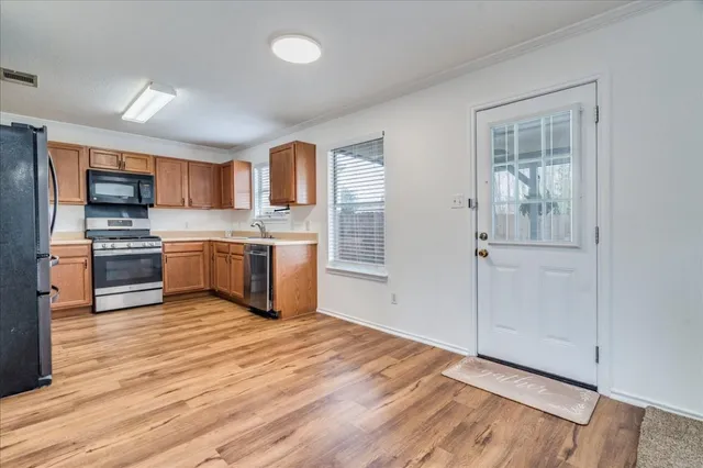 a kitchen with granite countertop cabinets stainless steel appliances and a sink