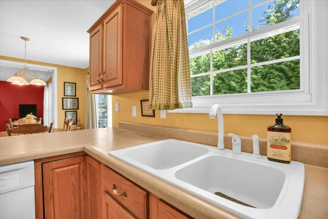a kitchen with a sink and a large window