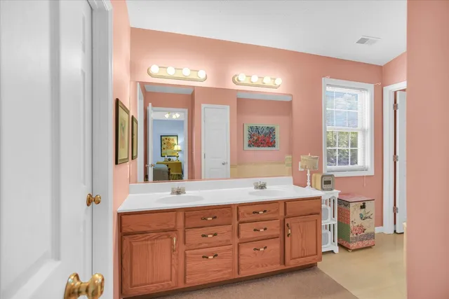 a spacious bathroom with a granite countertop sink and a mirror