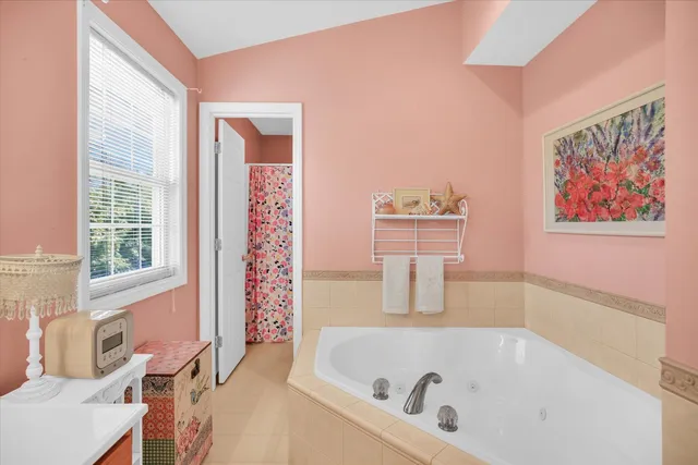 a bathroom with a tub and a window