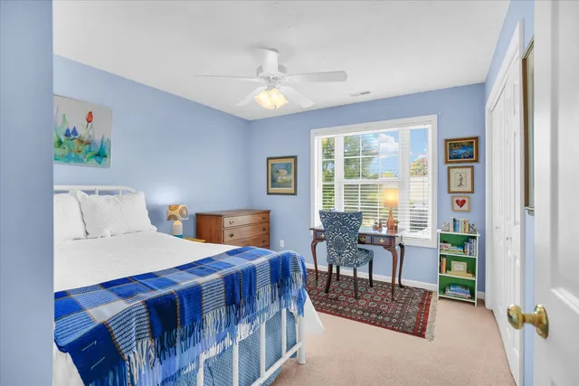 a bedroom with furniture and a large window