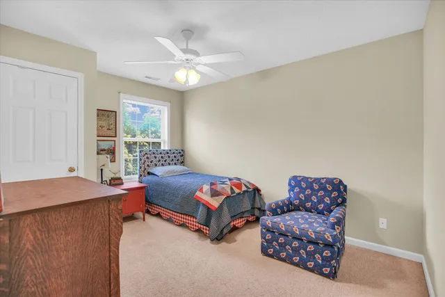 a bedroom with two beds and a chandelier