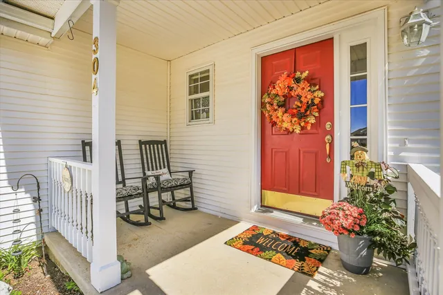 a front view of a house with outdoor seating