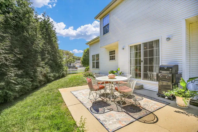 a view of a patio with couches table and chairs and potted plants