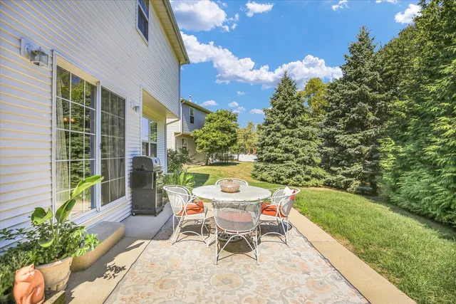 a table and chairs in patio of the house