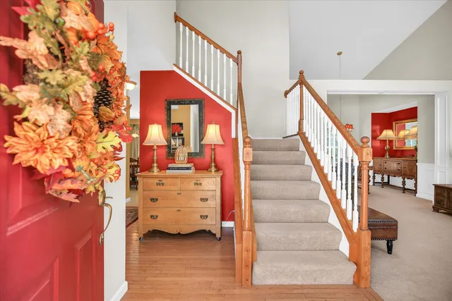 a view of staircase with white walls and wooden floor