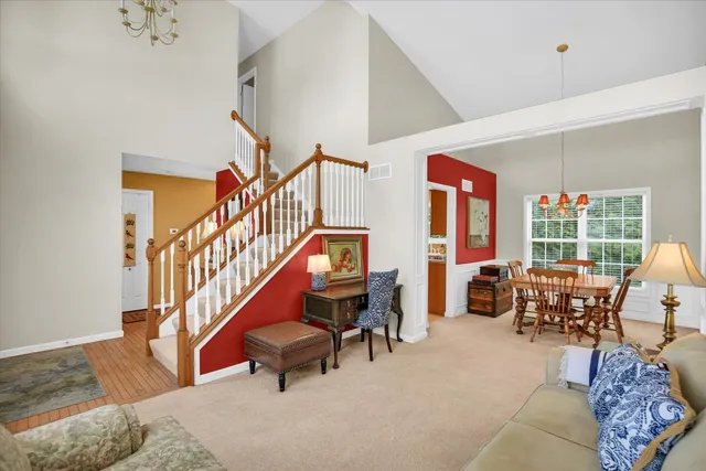 a living room with furniture stairs and a rug