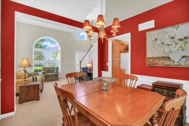 a dining room with furniture and a chandelier