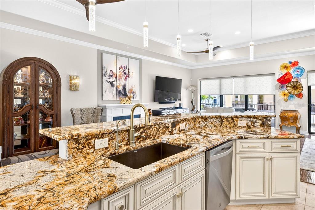 105 Wimbledon Court Redington Shores, FL 33708 - Photo 11 of 89 a kitchen with stainless steel appliances kitchen island granite countertop a sink and cabinets
