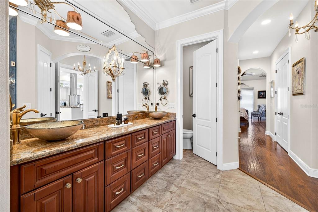 105 Wimbledon Court Redington Shores, FL 33708 - Photo 31 of 89 a spacious bathroom with a granite countertop sink mirror and a shower