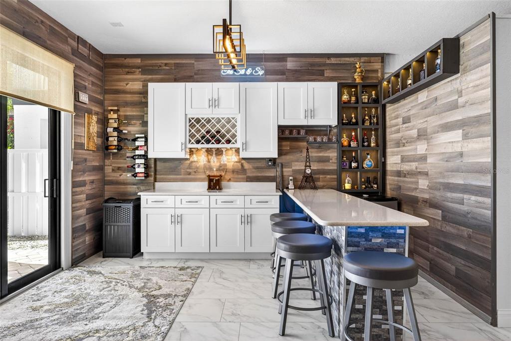 105 Wimbledon Court Redington Shores, FL 33708 - Photo 48 of 89 a kitchen with a refrigerator and cabinets