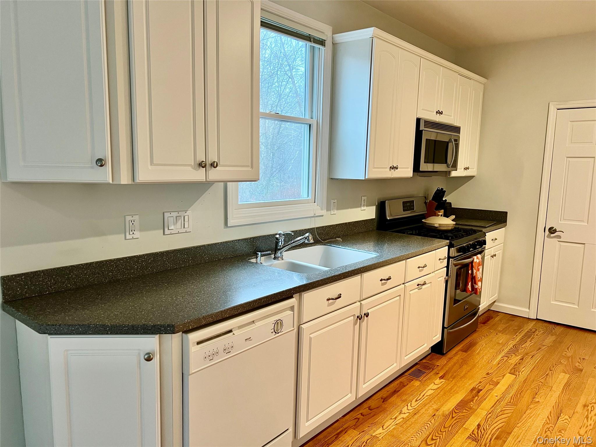 28 Clinton Corners Road Salt Point, NY 12578 - Photo 15 of 41 a kitchen with granite countertop white cabinets and a sink