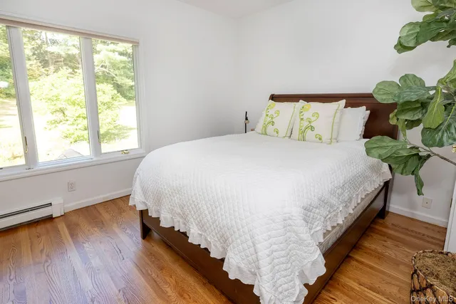 a large bed sitting in a bedroom next to a window