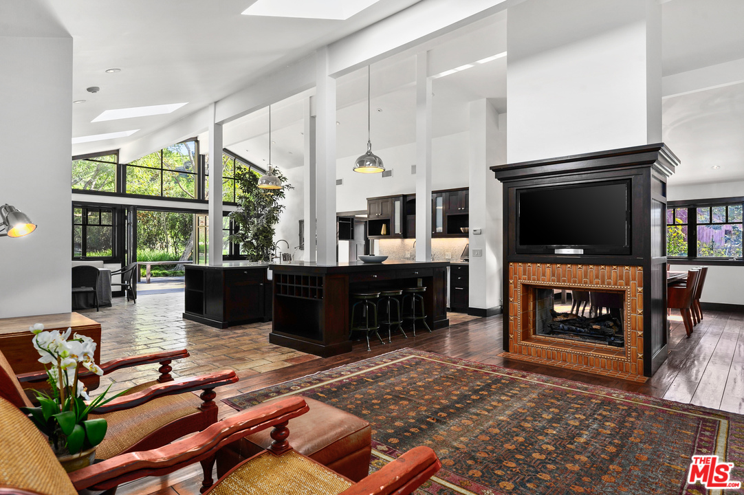 6172 Bonsall Drive Malibu, CA 90265 - Photo 13 of 40 a living room with furniture a flat screen tv and a fireplace