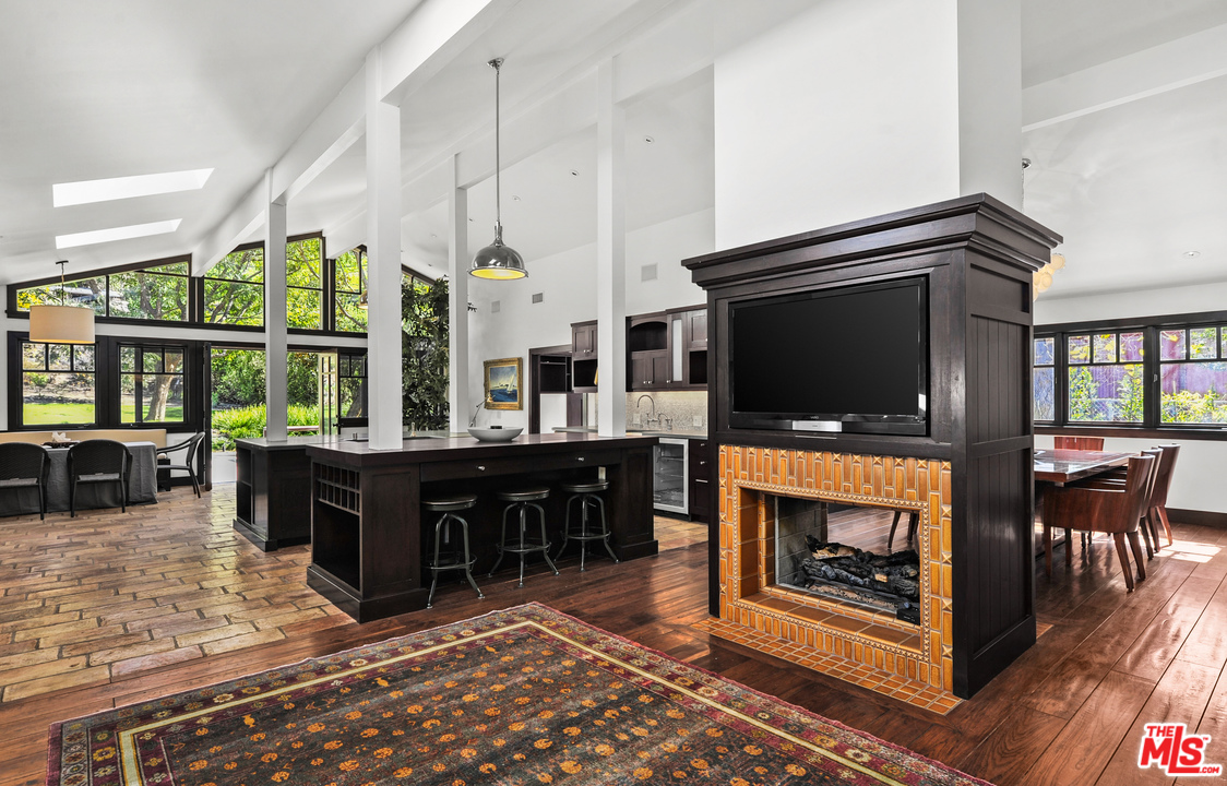 6172 Bonsall Drive Malibu, CA 90265 - Photo 14 of 40 a living room with furniture a flat screen tv and a fireplace