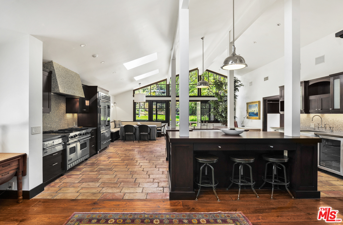 6172 Bonsall Drive Malibu, CA 90265 - Photo 15 of 40 a kitchen with stainless steel appliances granite countertop a stove and a wooden floor