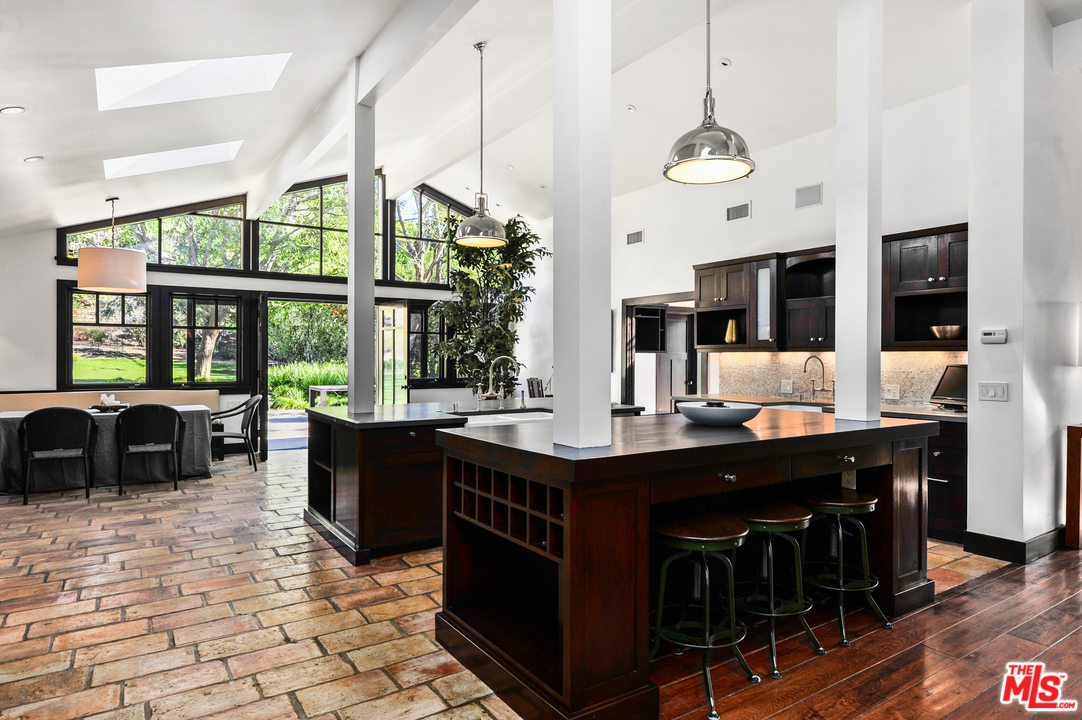6172 Bonsall Drive Malibu, CA 90265 - Photo 16 of 40 a large kitchen with a table and chairs