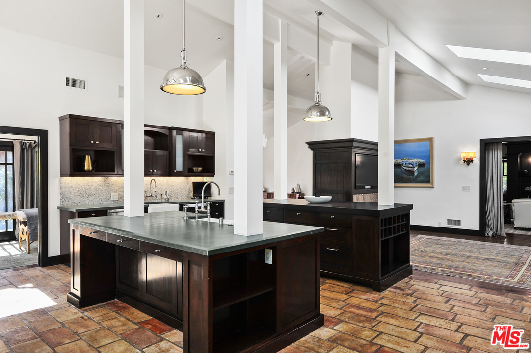 6172 Bonsall Drive Malibu, CA 90265 - Photo 21 of 40 a kitchen with a stove kitchen island and living room