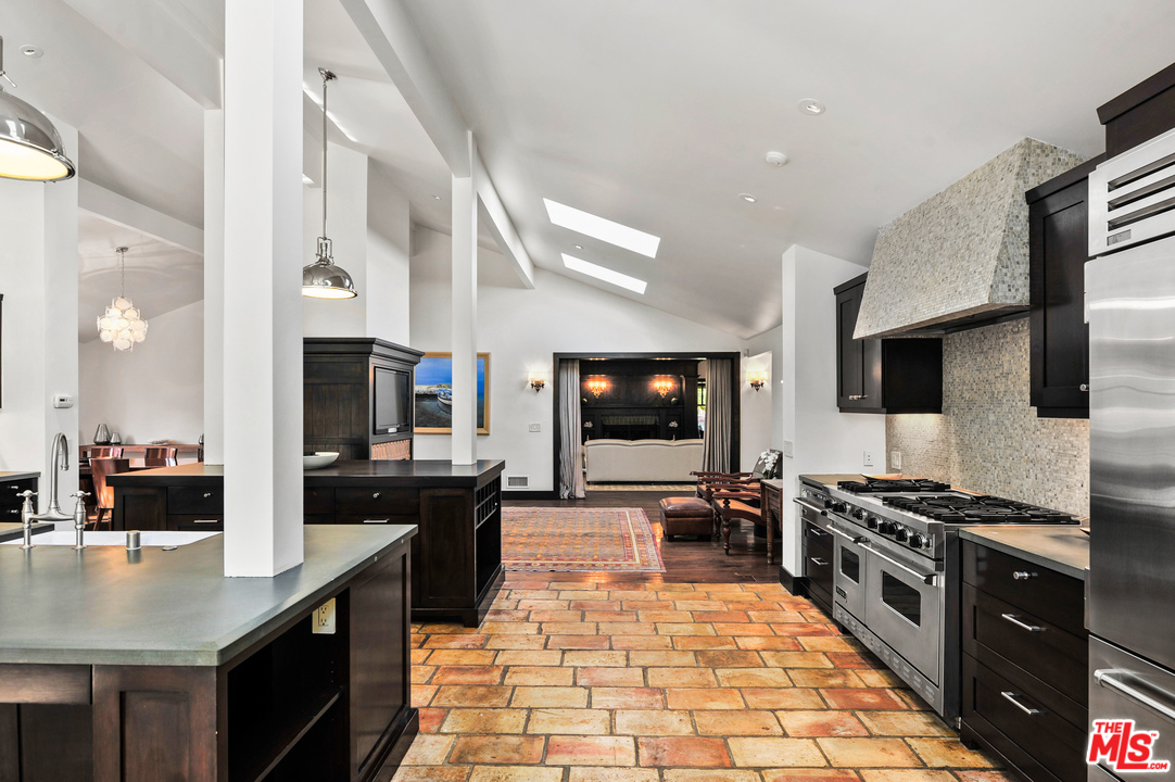 6172 Bonsall Drive Malibu, CA 90265 - Photo 22 of 40 a kitchen with stainless steel appliances a stove a sink a microwave and a refrigerator