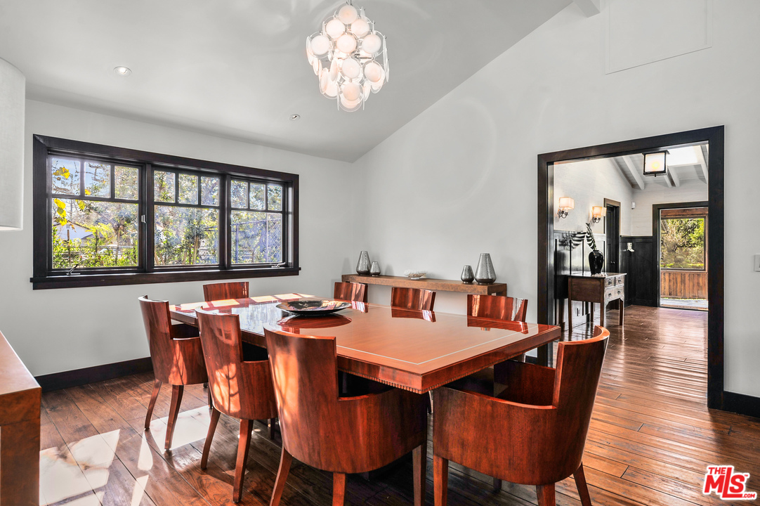 6172 Bonsall Drive Malibu, CA 90265 - Photo 23 of 40 a view of a dining room with furniture wooden floor and a chandelier
