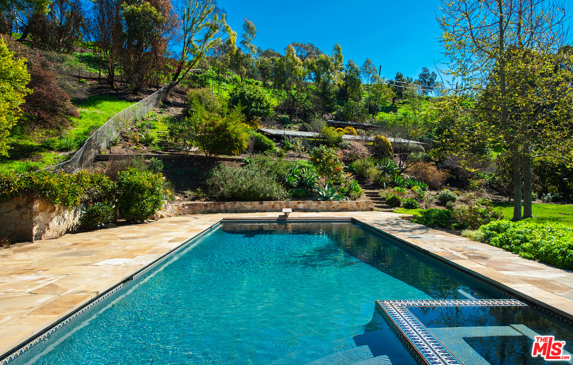 6172 Bonsall Drive Malibu, CA 90265 - Photo 25 of 40 a view of a swimming pool with a yard