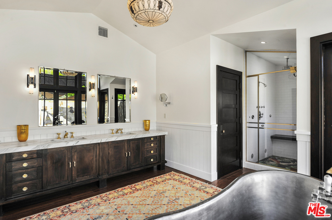 6172 Bonsall Drive Malibu, CA 90265 - Photo 34 of 40 a spacious bathroom with a double vanity sink and a mirror