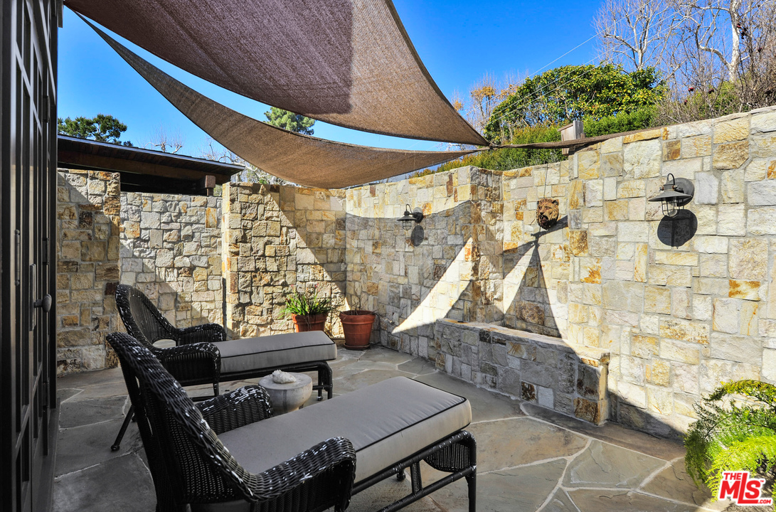 6172 Bonsall Drive Malibu, CA 90265 - Photo 36 of 40 a view of a patio with table and chairs and potted plants