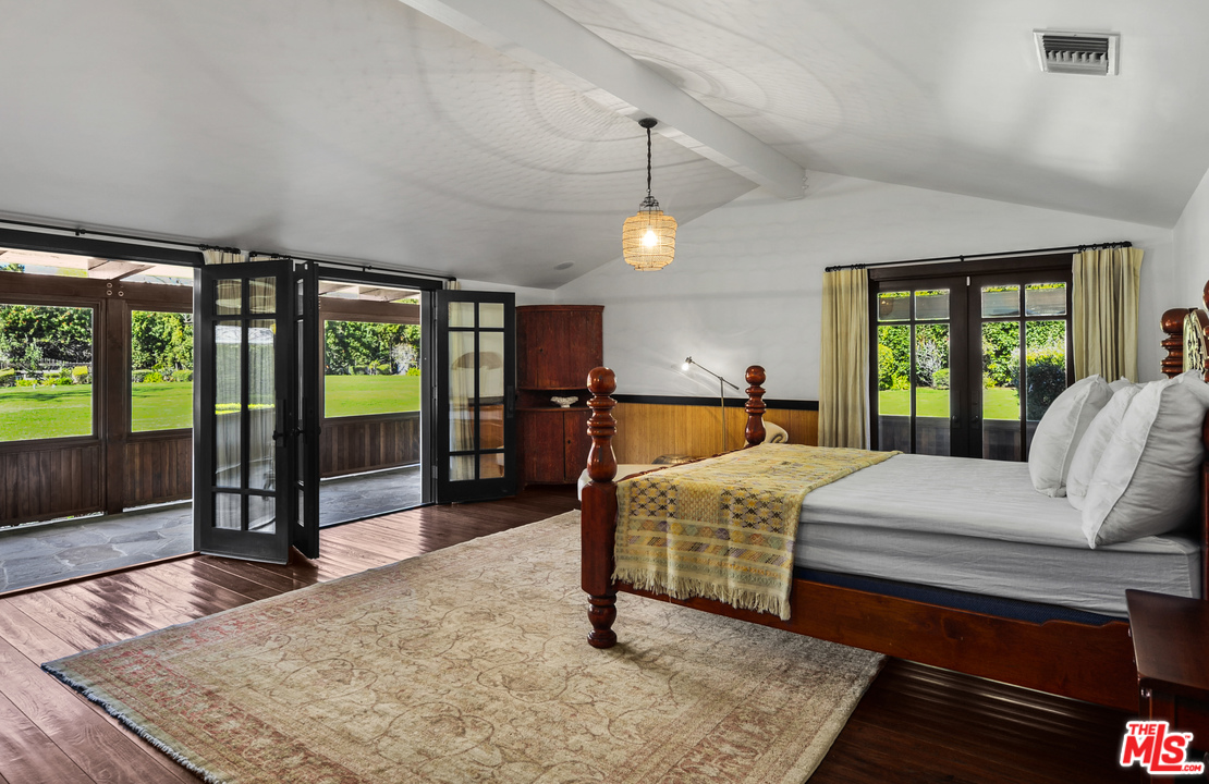 6172 Bonsall Drive Malibu, CA 90265 - Photo 37 of 40 a bedroom with a bed and wooden floor