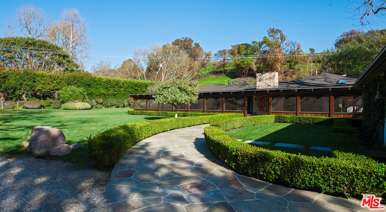 6172 Bonsall Drive Malibu, CA 90265 - Photo 5 of 40 a view of a house with a yard and potted plants