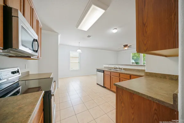 a kitchen with stainless steel appliances granite countertop a sink and a stove