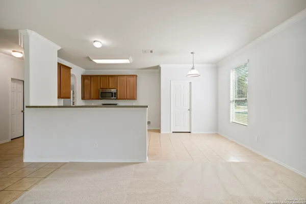 a view of a kitchen with a sink and a mirror