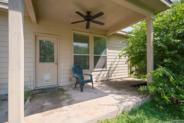 a backyard of a house with table and chairs