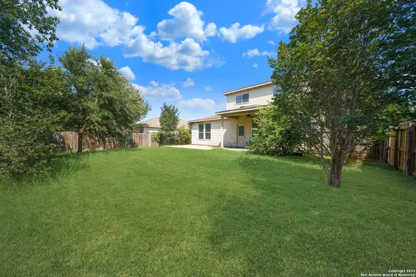 a view of a house with a back yard