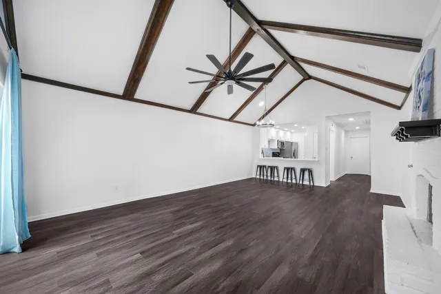 a view of a livingroom with furniture and hardwood floor