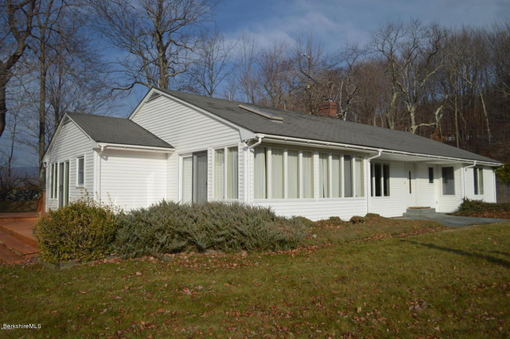 281 Whitman Road Hancock, MA 01267 - Photo 1 of 15 a house with green field in front of it