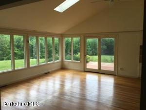 281 Whitman Road Hancock, MA 01267 - Photo 5 of 15 a view of empty room with wooden floor and fan